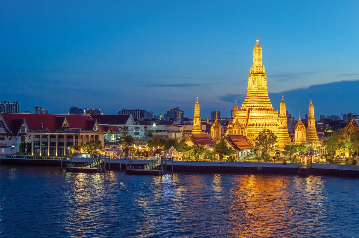 River view from a bar in Bangkok, overlooking Thai temple Wat Arun a famous landmark of Thailand.