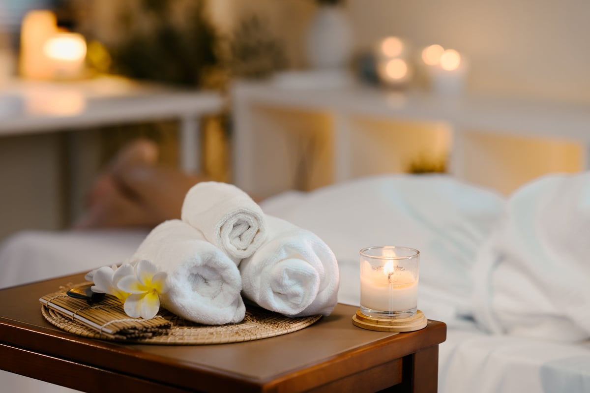 Tranquil spa room with towels and candle