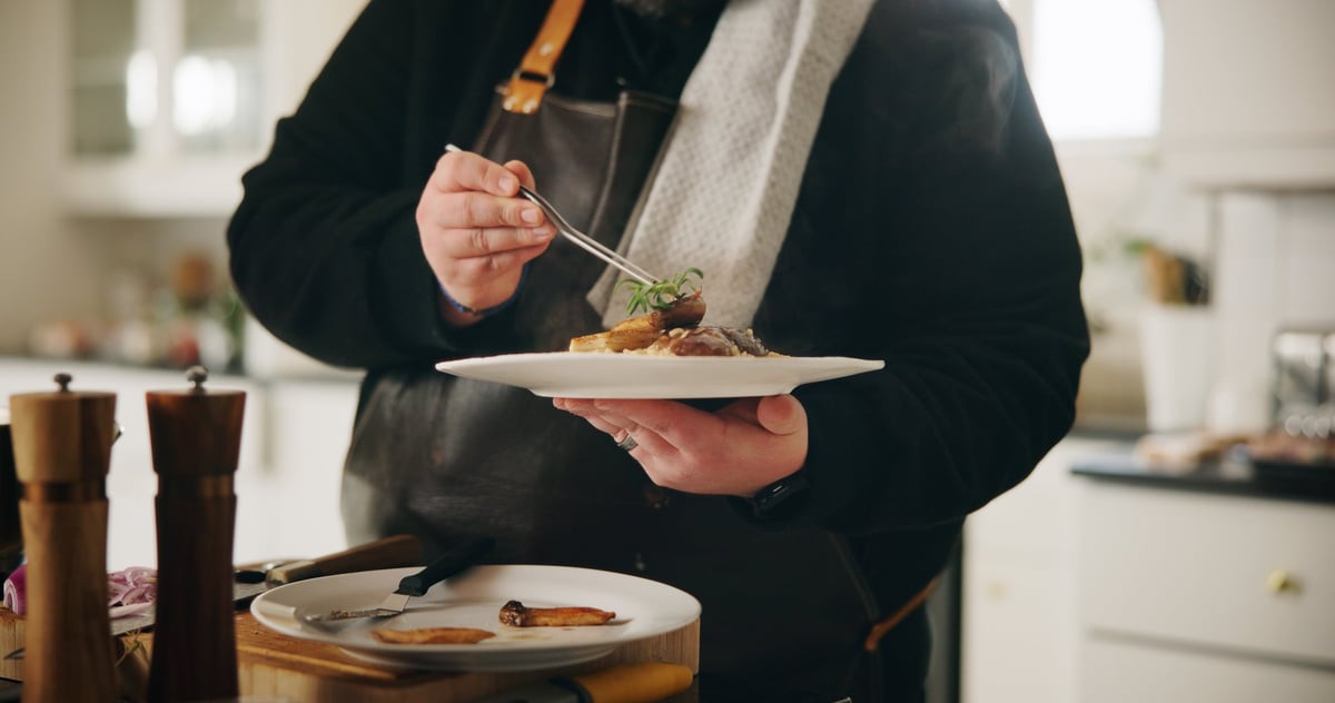 Chef plate and hands of man with food in kitchen of home