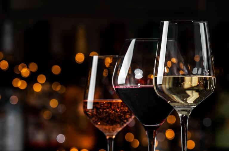 An array of wine glasses showcases red, rose, and white wines
