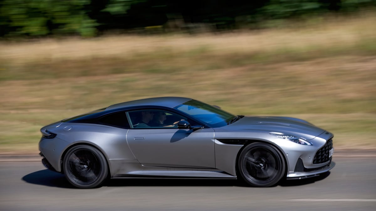 2023 silver Aston Martin DB12 V8 car driving on a British road