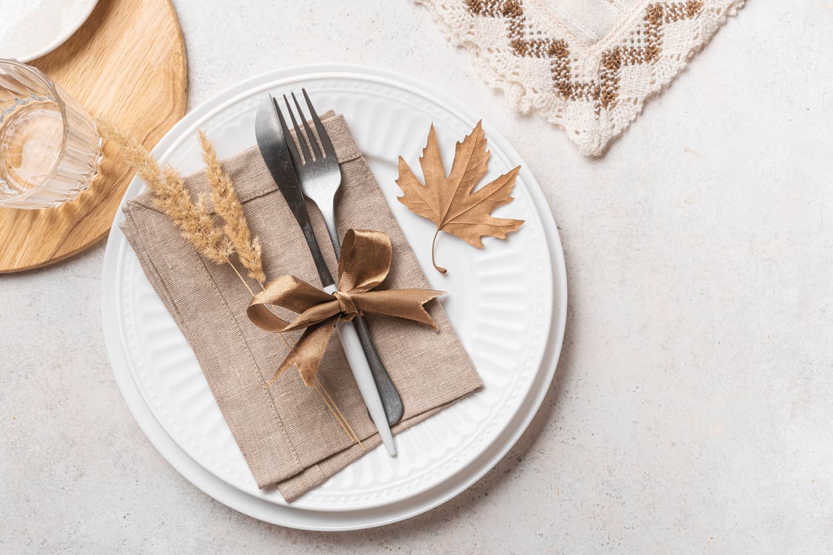 Elegant autumn table setting with maple leaves