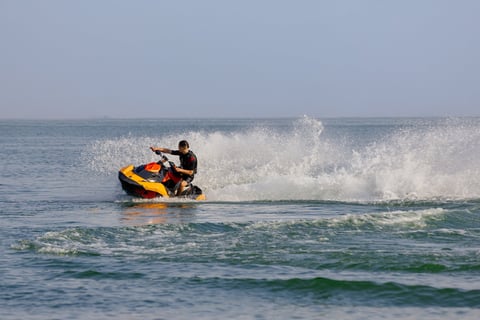 Man riding jet ski spray