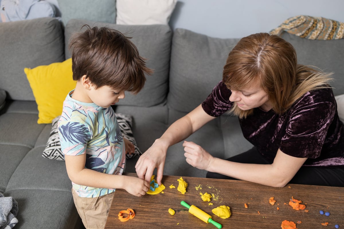 Babysitter and little boy enjoying creative playtime