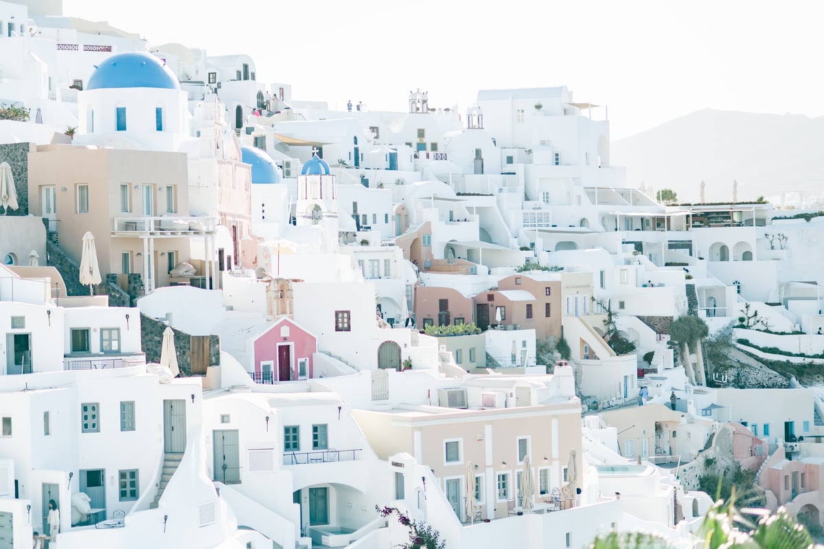 Luxury Mykonos beach club with white architecture and Aegean Sea views