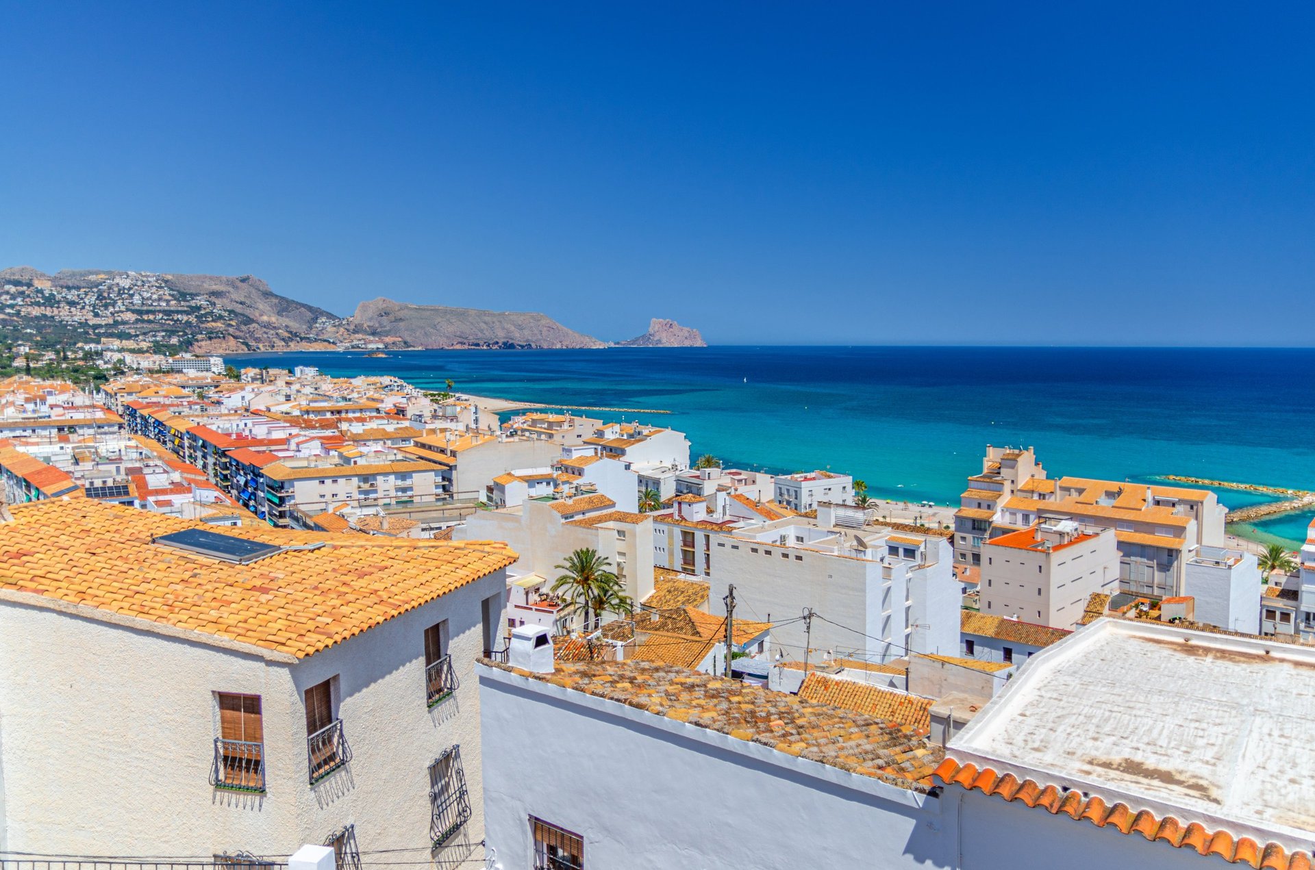 Aerial view of Mykonos white buildings and blue Mediterranean Sea, Greece