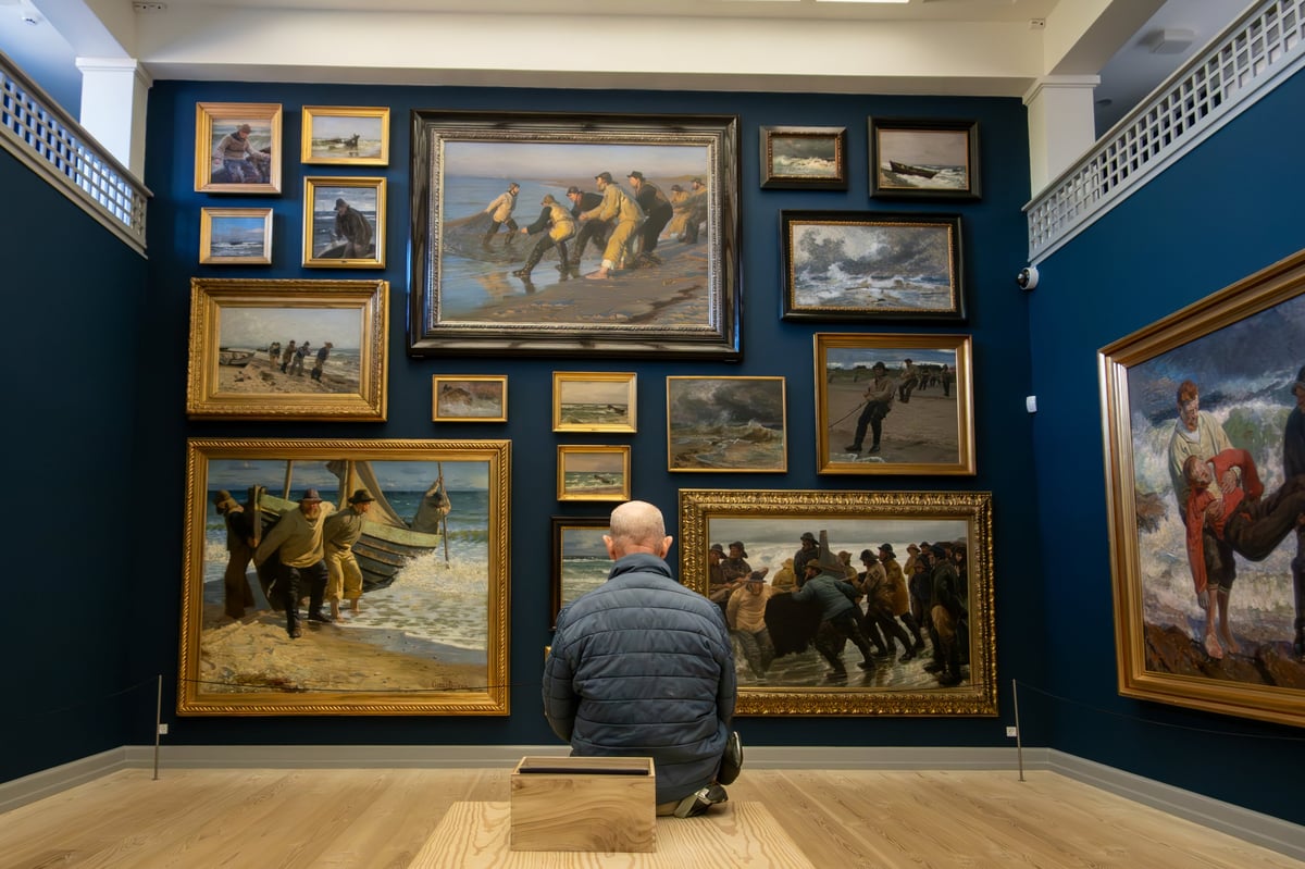 Man sitting in art museum gallery space