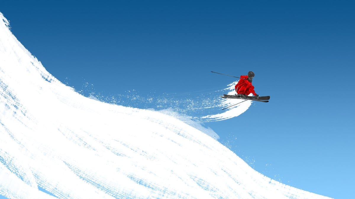 Male skier jumping across steep white slope on blue sky