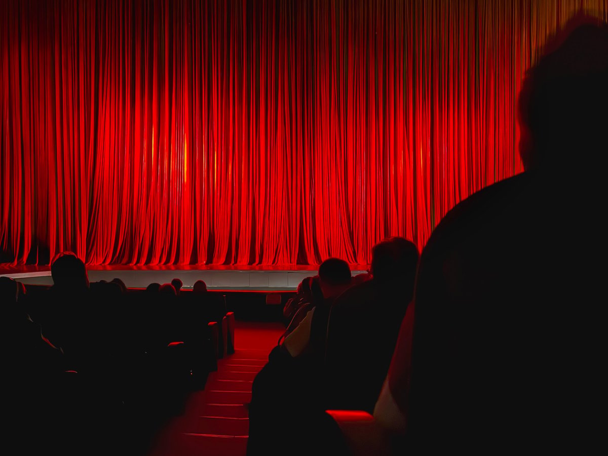 Red Theater Curtain illuminated by warm stage lights