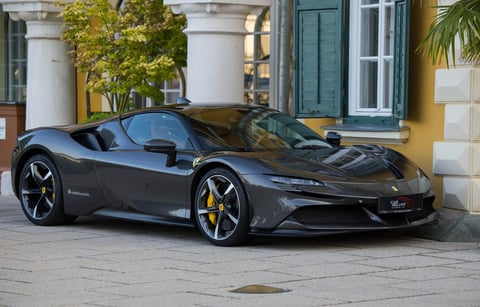 Ferrari SF90 Stradale parked near a historic building