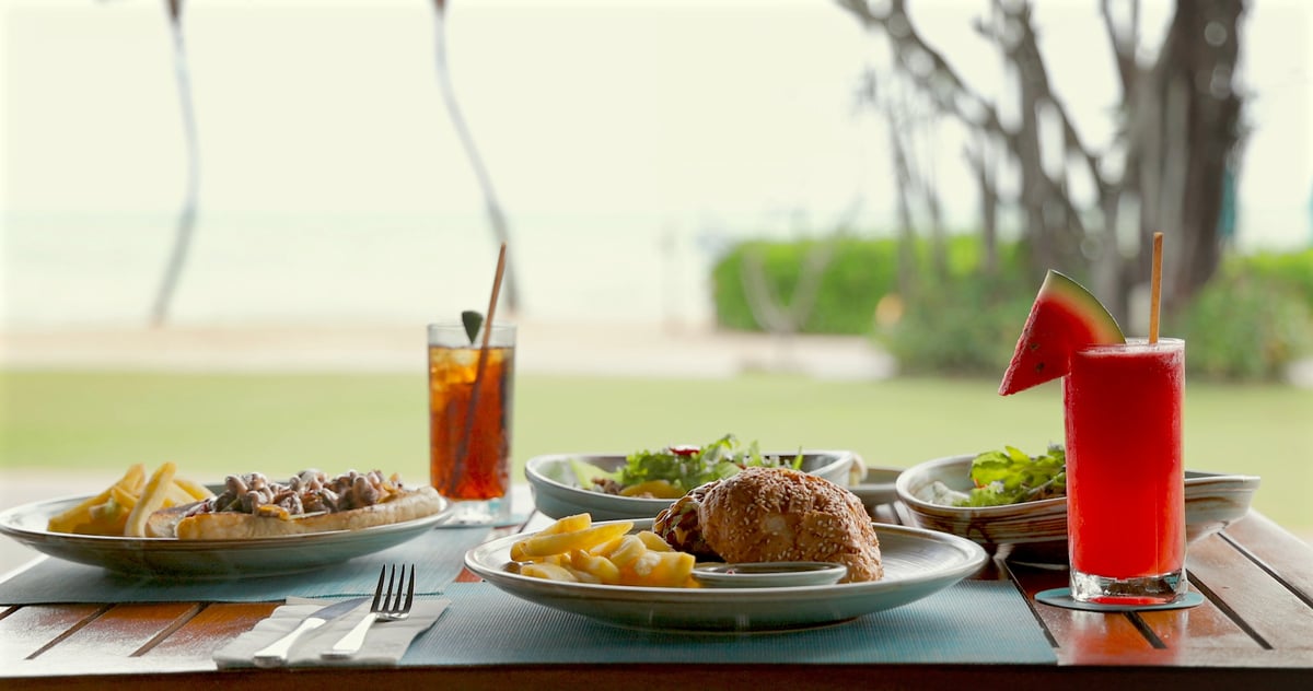 Beachfront dining with elegant outdoor meal setting by the sea