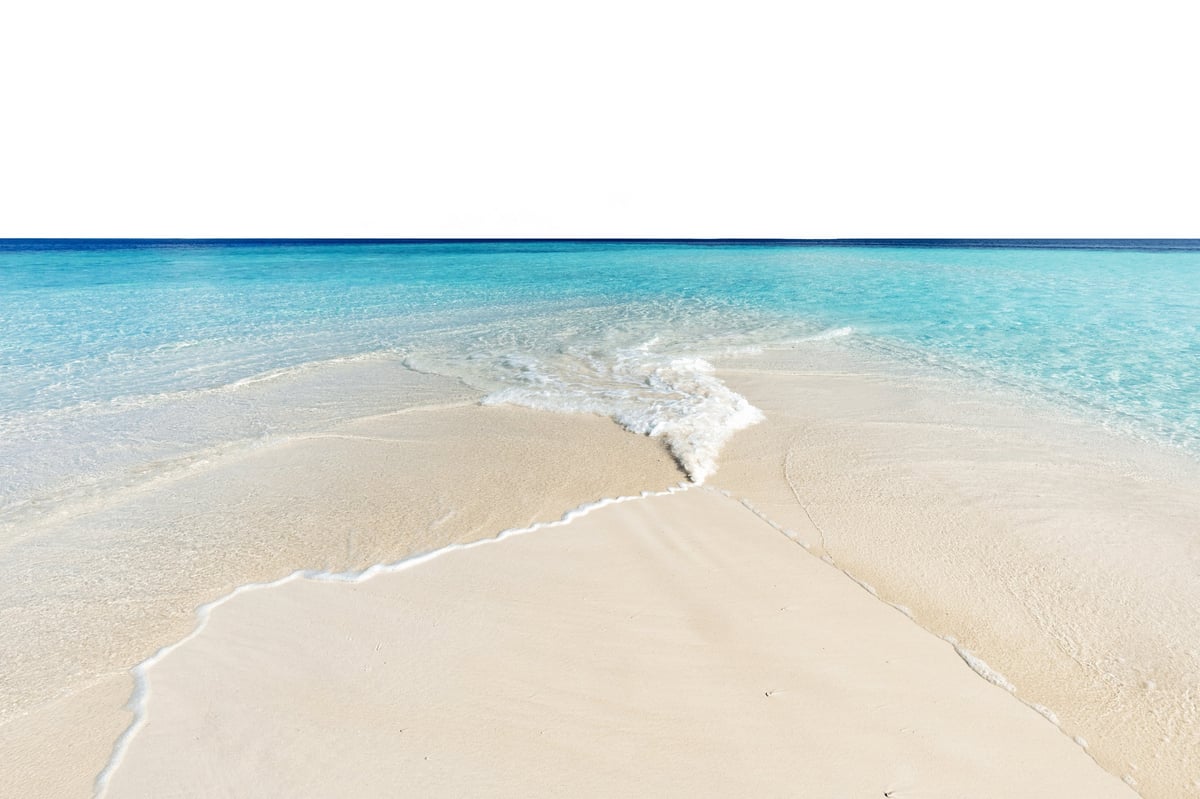 Pristine white sand beach with gentle waves and turquoise water in Turks and Caicos