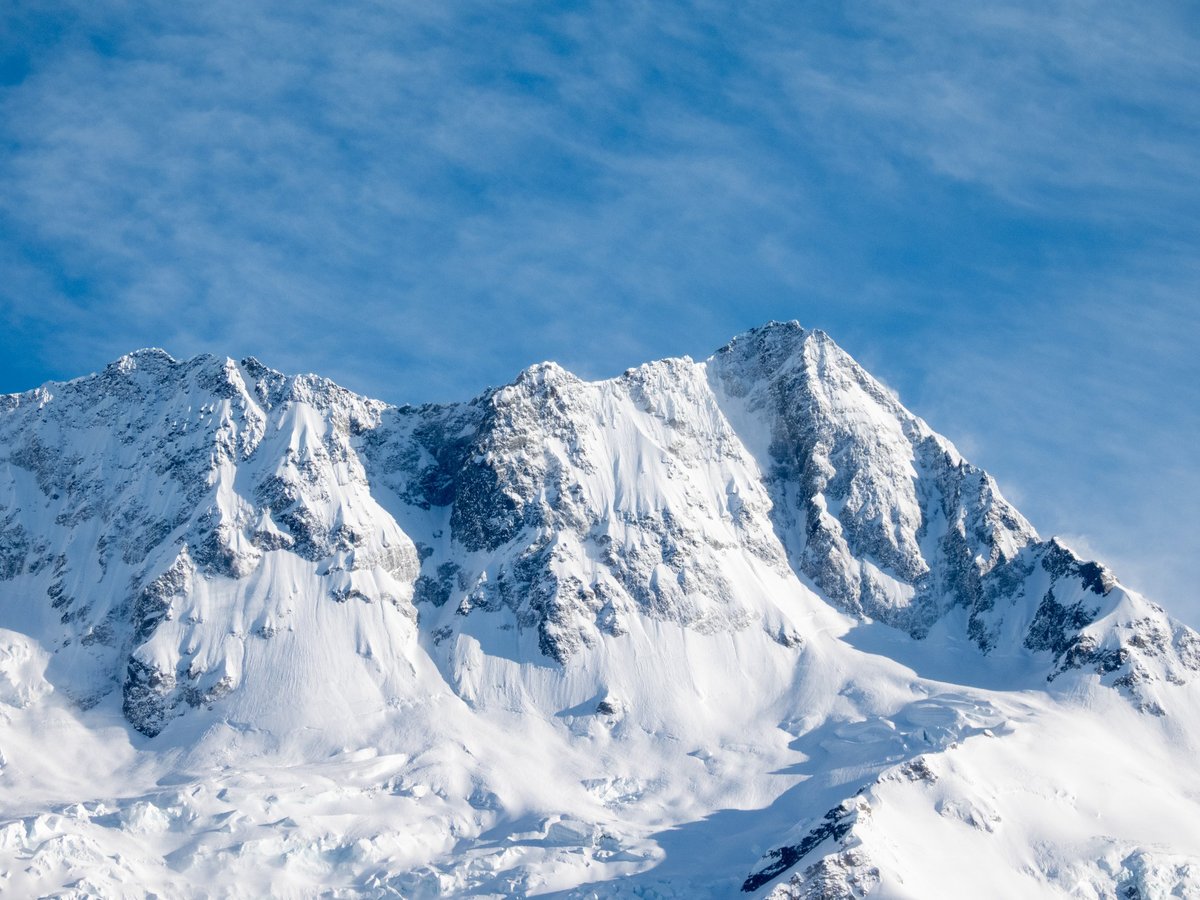 The sun rising over mountain range alpine landscape