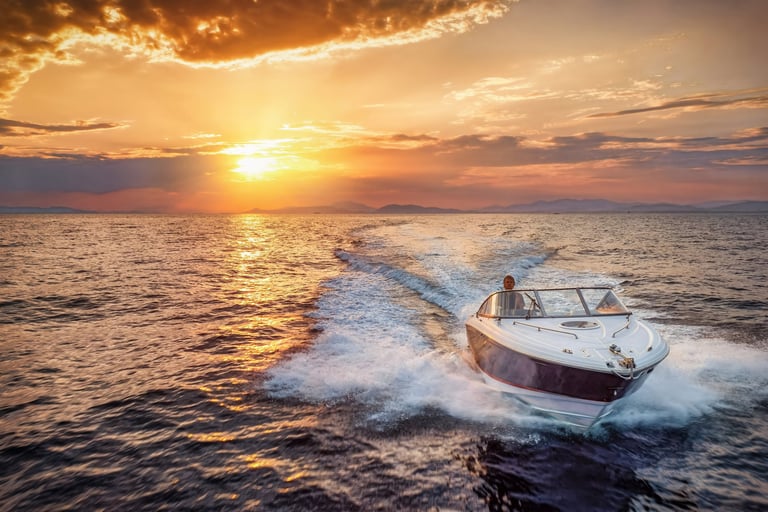 Aerial view of a motor speedboat cruising over the ocean during golden sunset
