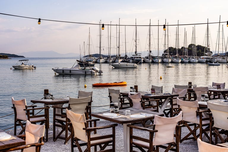 Seaside restaurant with marina view at sunset in Skiathos, Greece