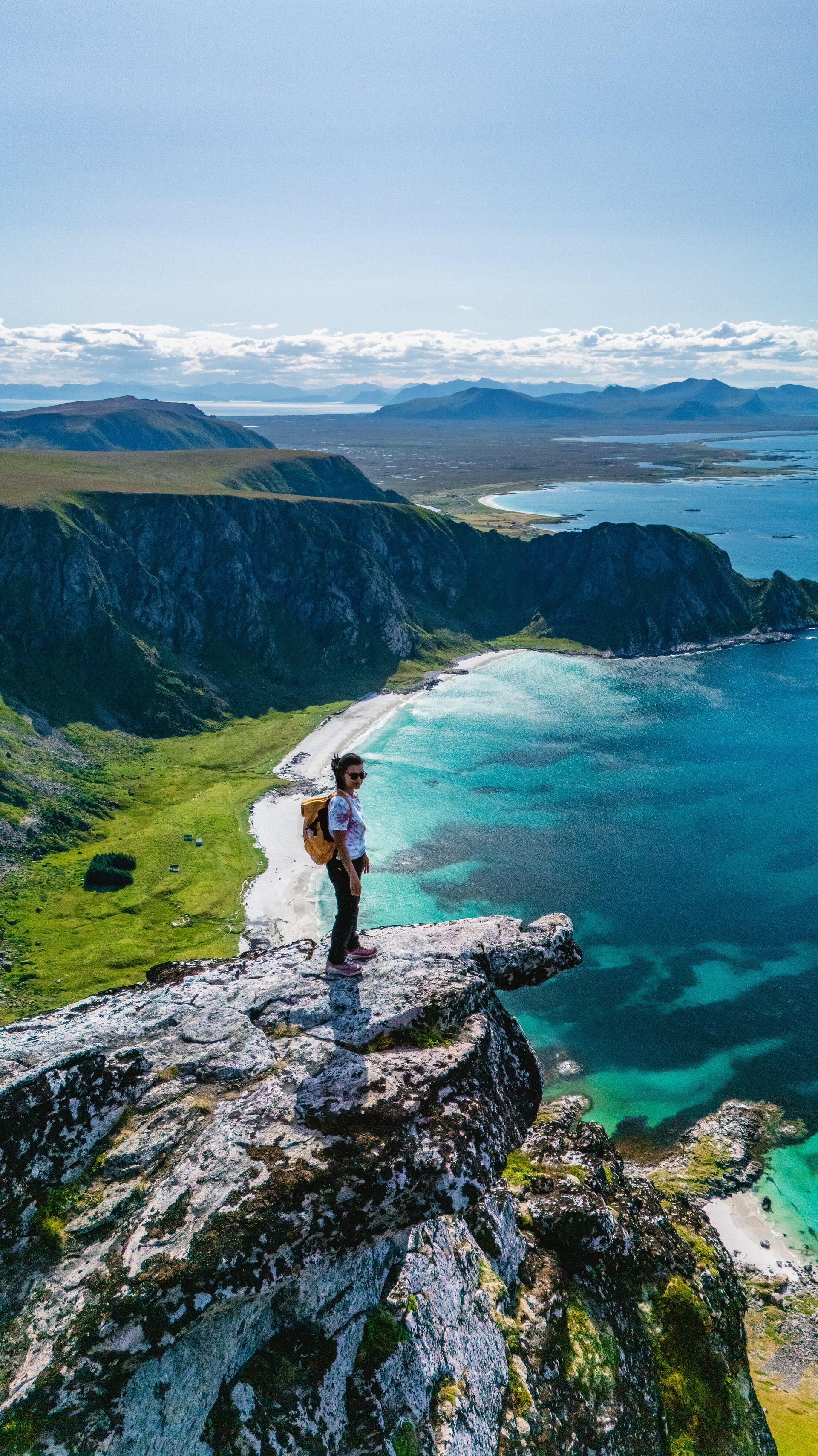Explore the stunning vistas from Matind Mountain in Bleik, Andoya, where rugged cliffs meet the sparkling turquoise waters