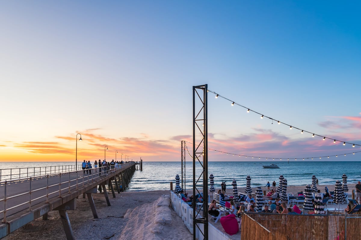 People enjoying sunset at beach club with ocean views