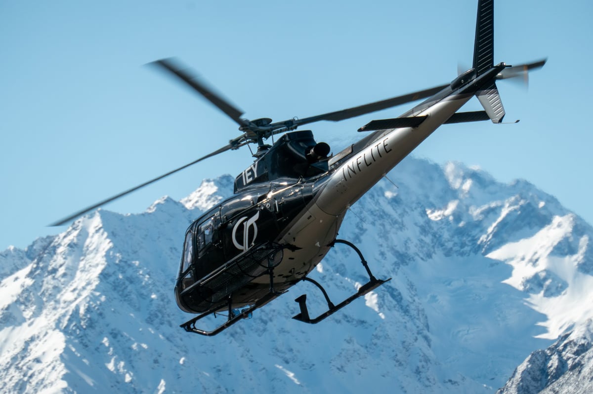 An Inflite Airbus Helicopters H125 taking off from Mount Cook Airport with Aoraki Mount Cook in background