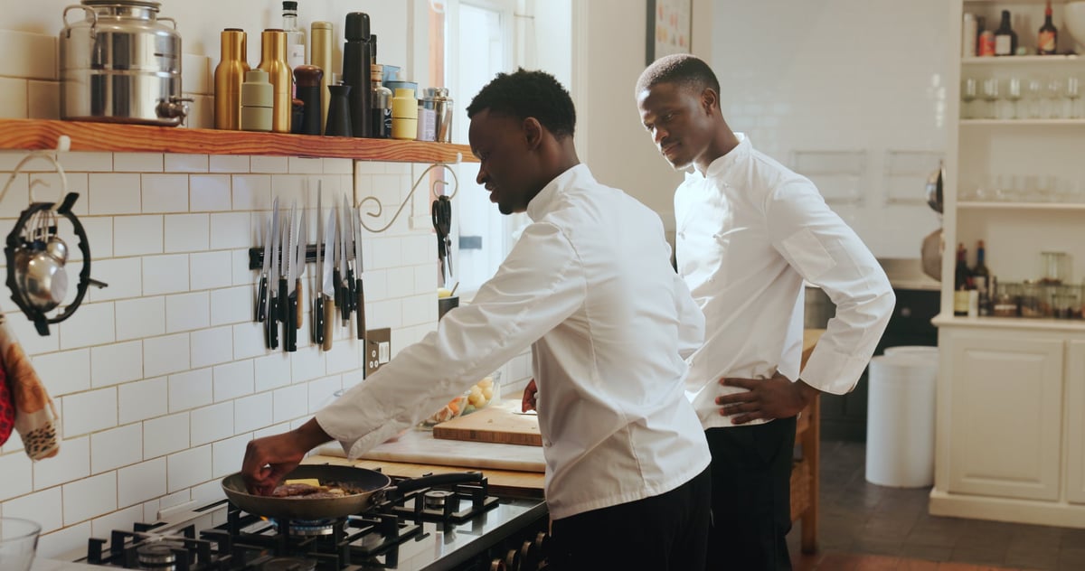 Private chef teaching cooking in a home culinary course with student