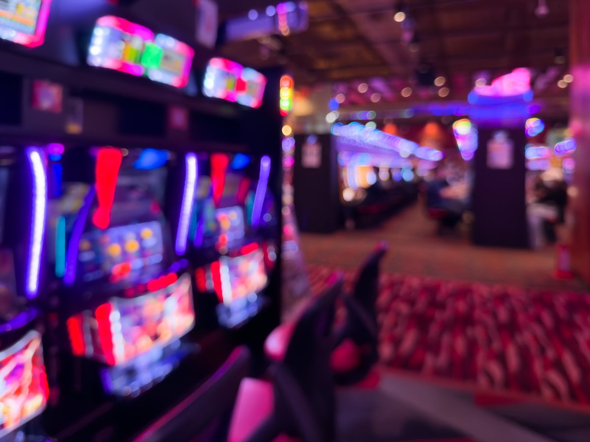 Defocused Pachinko Parlor Background with Abstract Neon Slot Machine Lights