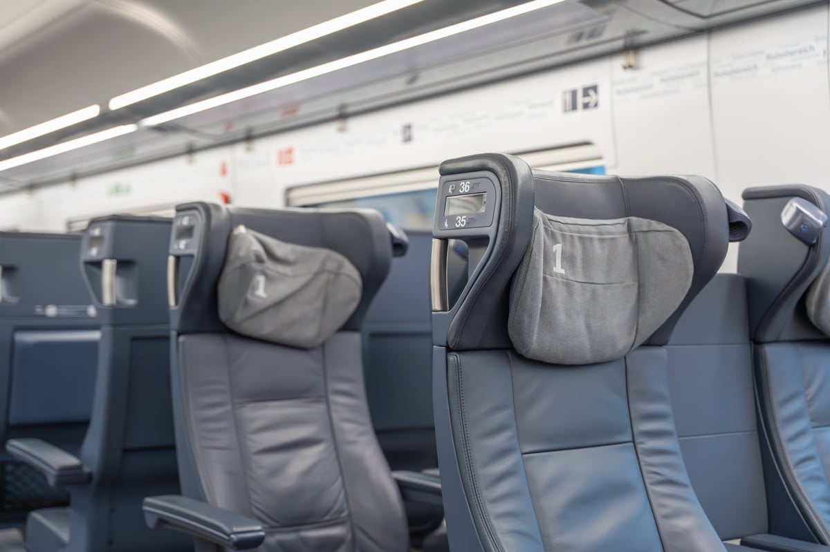 Detailed view of first-class seat with grey headrest cover