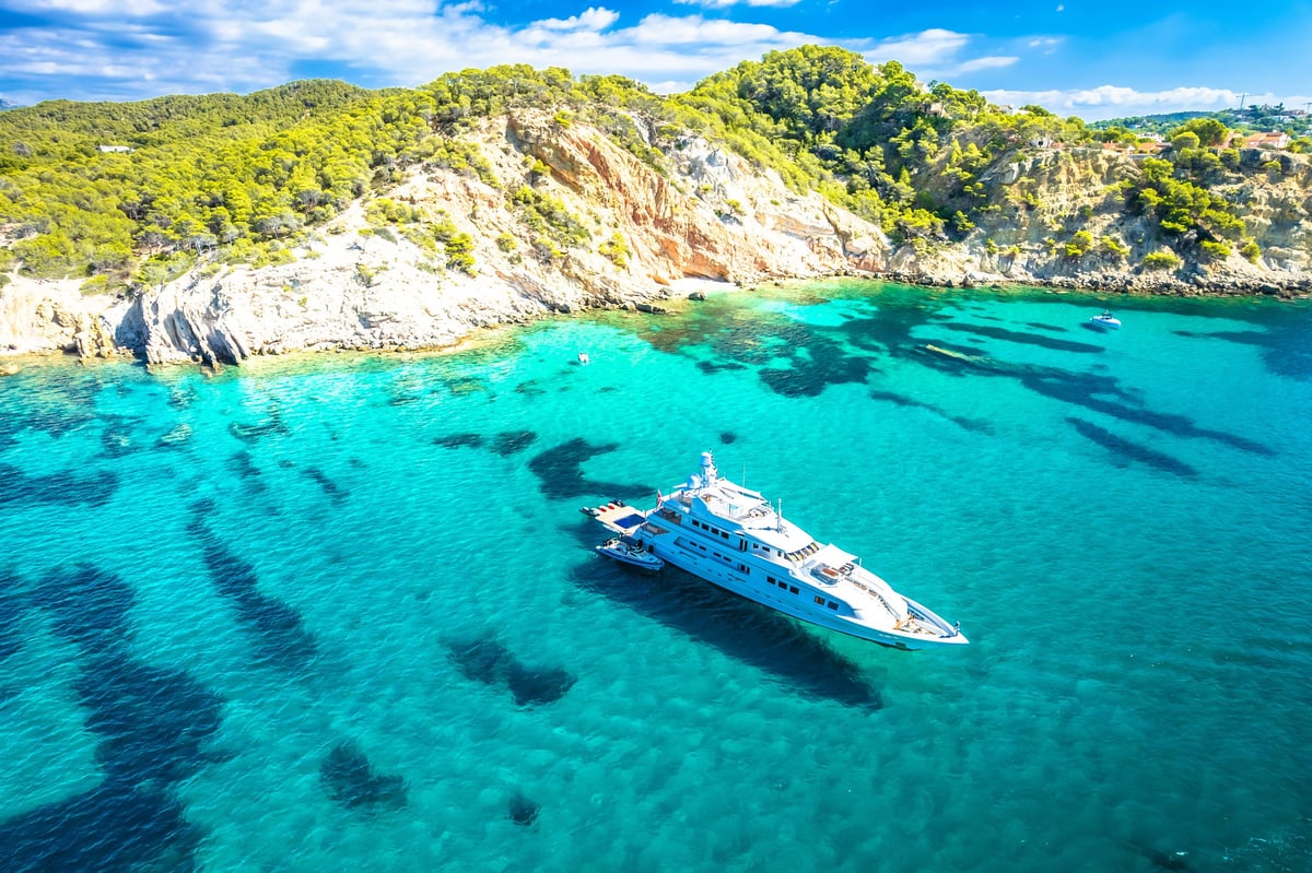 Superyacht on turquoise Mediterranean sea on coast of Mallorca aerial view, Peguera, Balearic islands of Spain