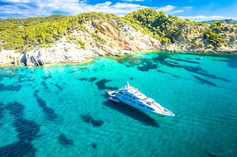 Superyacht on turquoise Mediterranean sea on coast of Mallorca aerial view, Peguera, Balearic islands of Spain