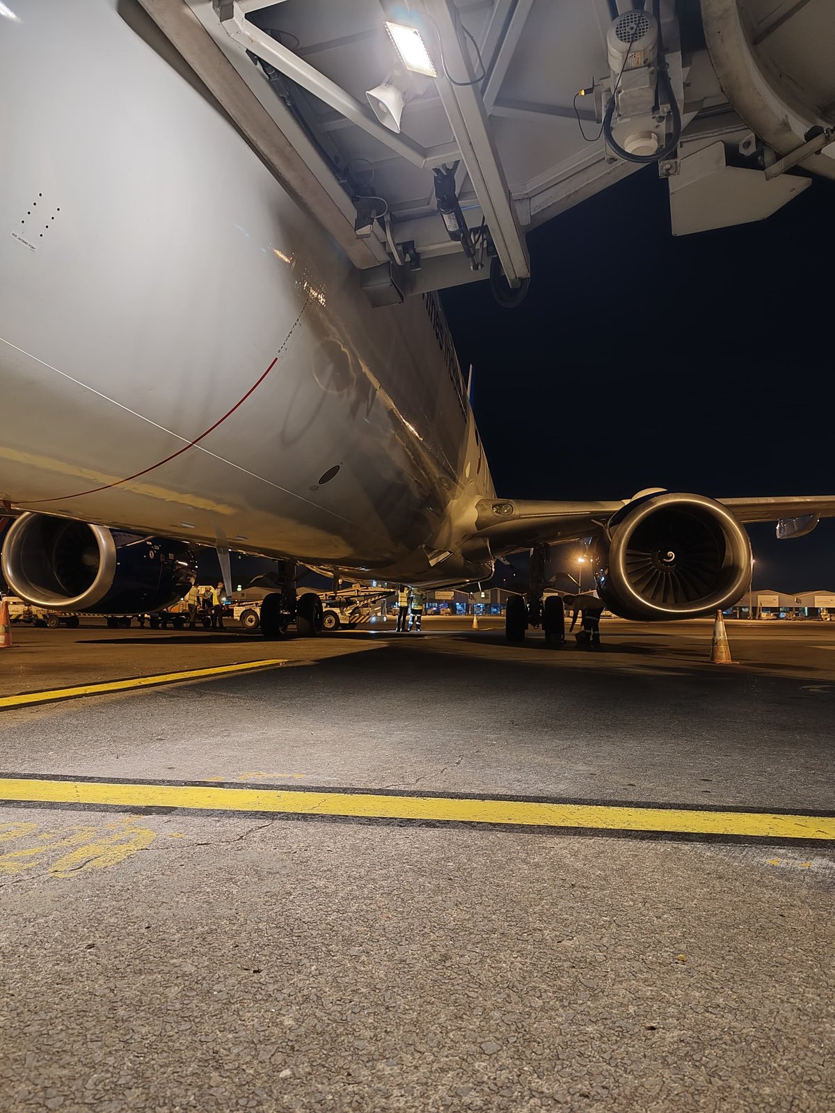 Airplane Side View from Below at Airport Gate