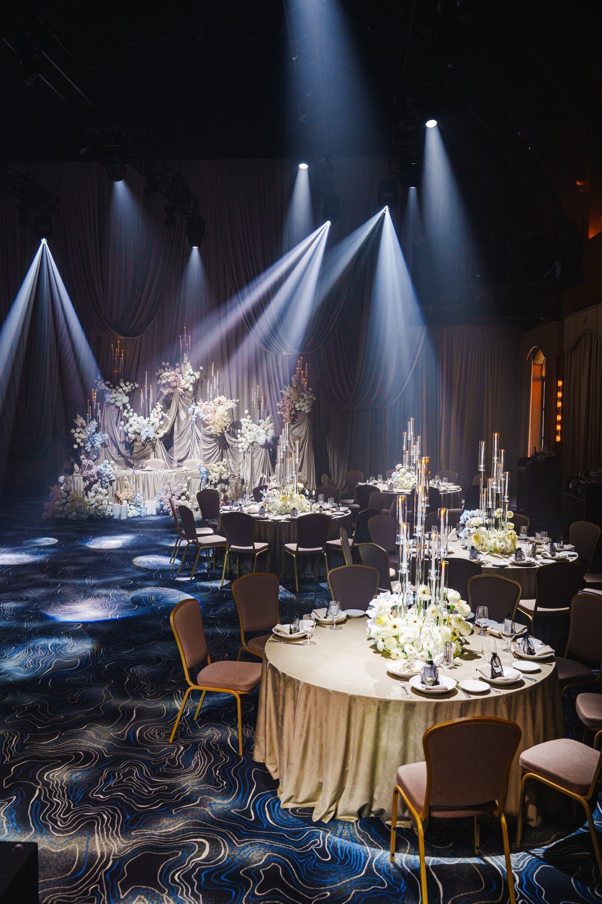 Tables are beautifully arranged in a luxurious ballroom