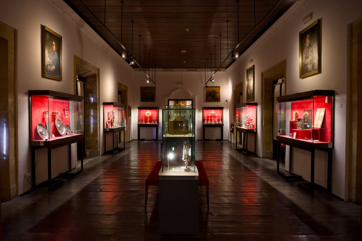 Museum exhibition hall with illuminated display cases and art