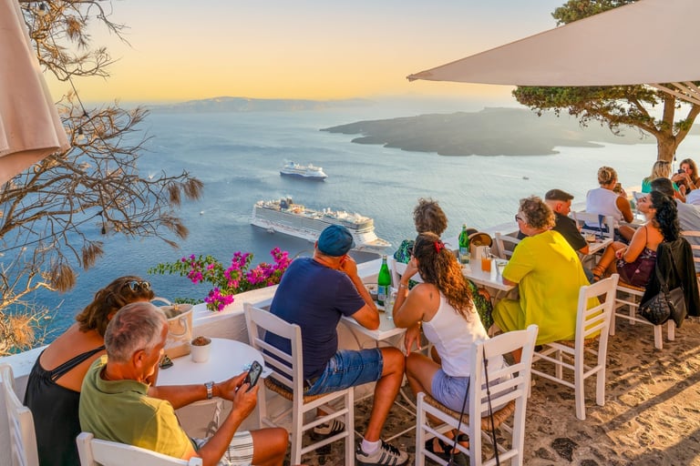Fira, Santorini - Tourists enjoying dinner with stunning Aegean Sea view