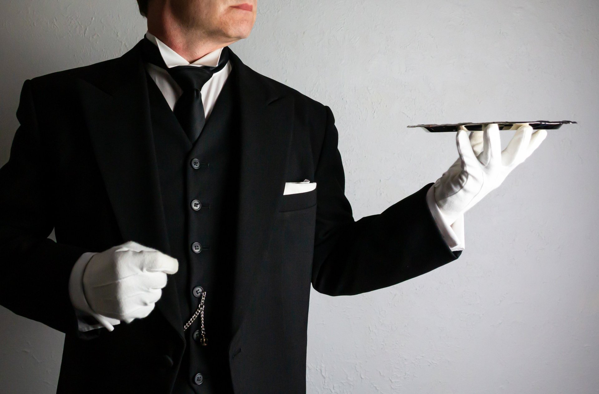 Butler with serving tray, luxury hotel service, tipping etiquette guide