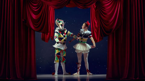 Life on stage. Mime and ballerina standing together on theater stage in colorful costumes. Concept of artistic collaboration, playfulness, emotional storytelling, and creative branding.