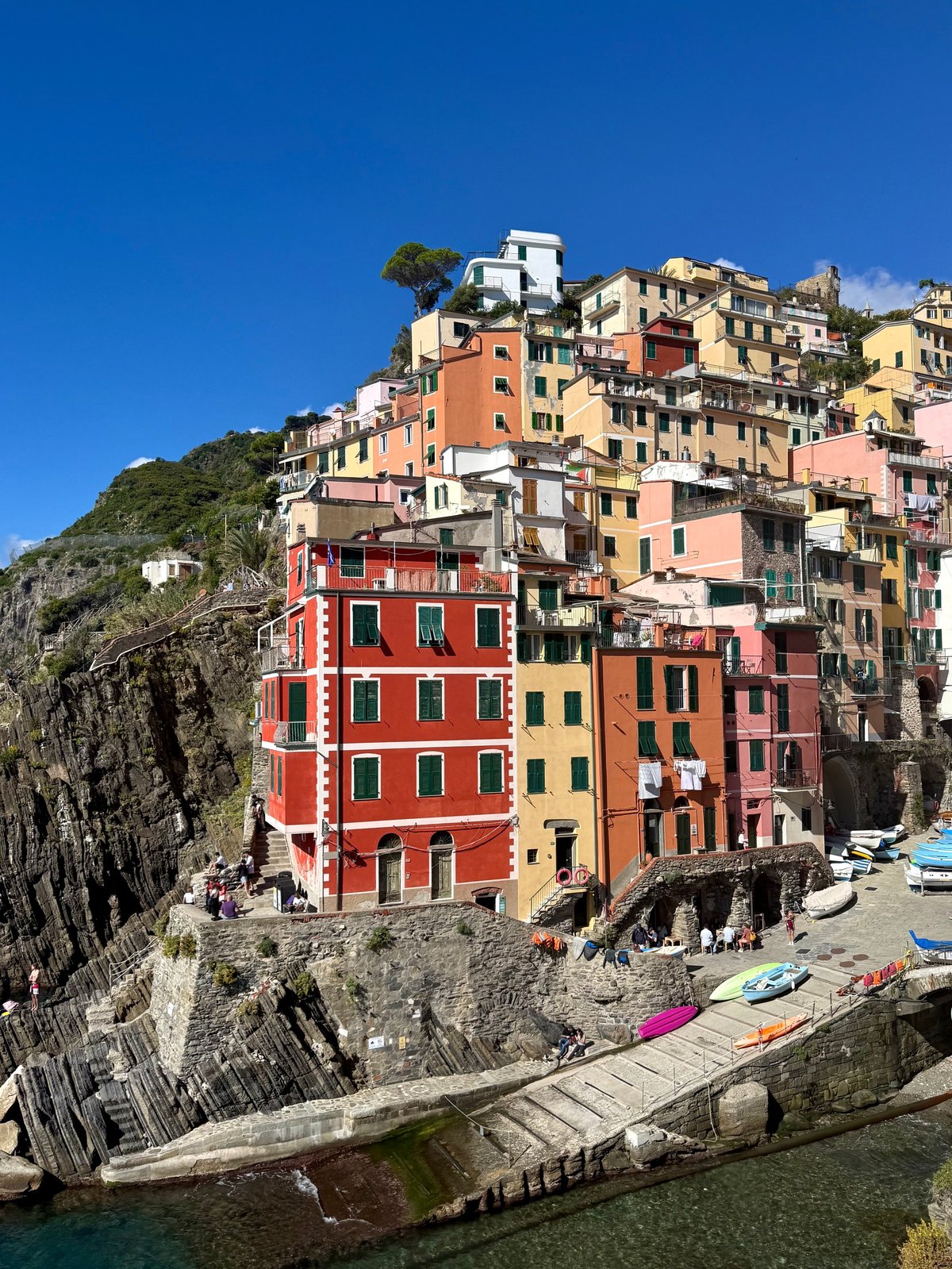Vibrant view of Riomaggiore colorful cliffside village, Cinque Terre, Italy