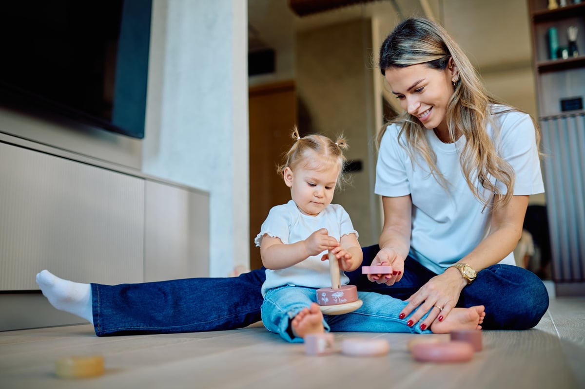 Mother and toddler playing together at home