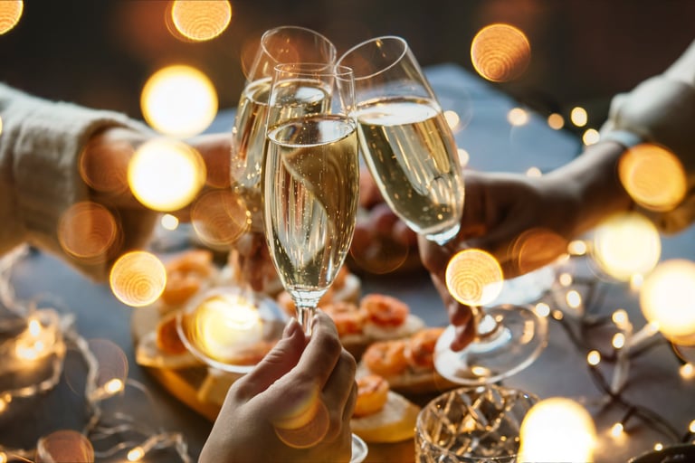 Friends celebrating party with champagne or sparkling wine