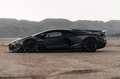 Black Lamborghini Revuelto parked in the desert showing the black wheel and fender