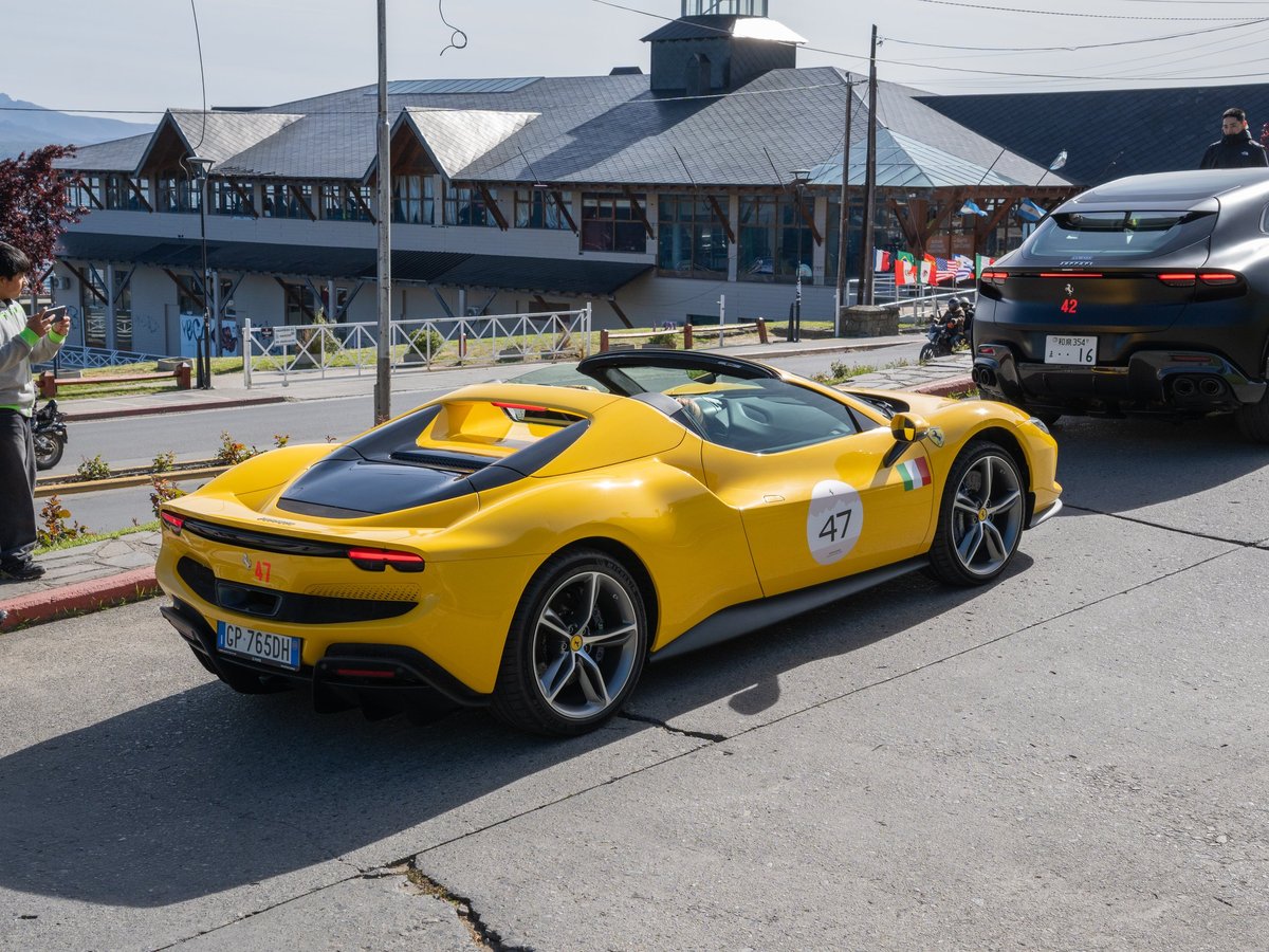 Yellow Ferrari luxury sports car driving during an exclusive automotive event in Argentina