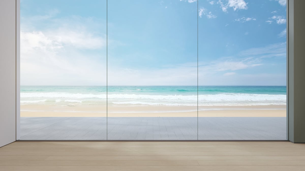 Wooden floor and large glass wall in vacation home or holiday villa