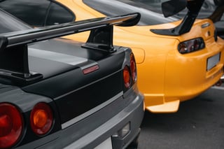 Yellow and grey exotic cars parked side by side