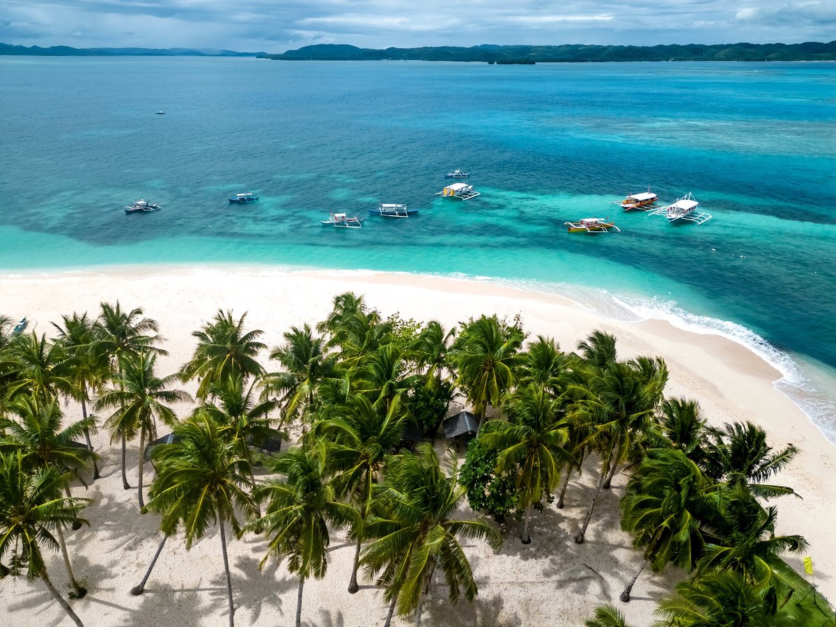 Daku Island Siargao Philippines tropical beach with palm trees