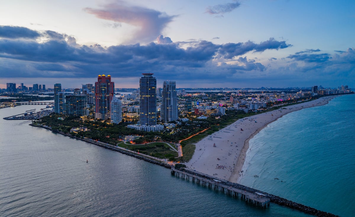 Aerial night view of Miami coastline and skyline at dusk