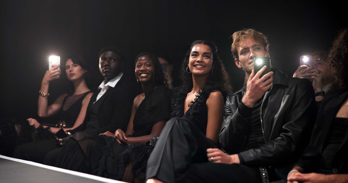 People, crowd and catwalk with phone for fashion show, garment collection or designer brand
