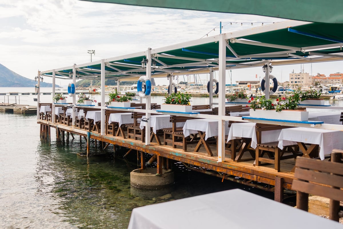 Outdoor cafe with sea view and wicker chairs