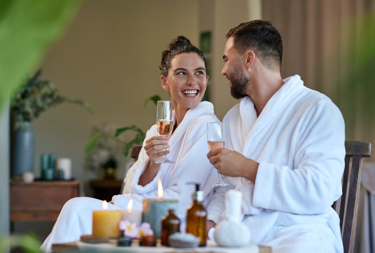 Romantic couple enjoying a luxury spa experience with candles and champagne