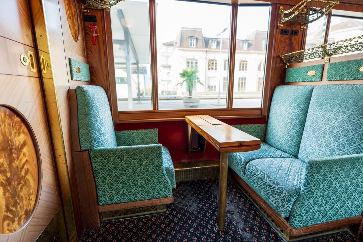 GoldenPass Line Belle Epoque train vintage interior with wood paneling and blue seats