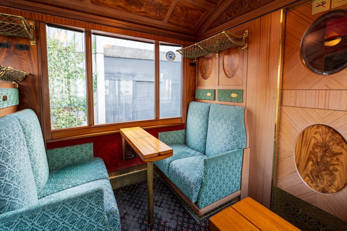 GoldenPass Line Belle Epoque train vintage interior with wood paneling and blue seats