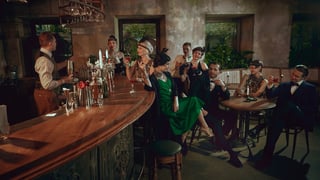 Vintage bar gathering with cheerful friends enjoying cocktails