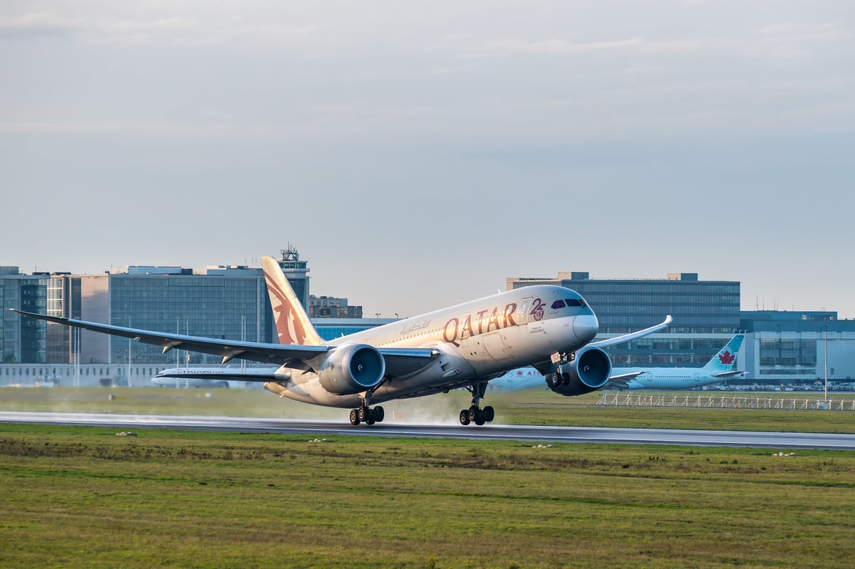 Brussels, Belgium - Dec 21, 2025: Qatar Airways Boeing 787 Dreamliner lifting off from the runway at Brussels Airport with terminal buildings in background.