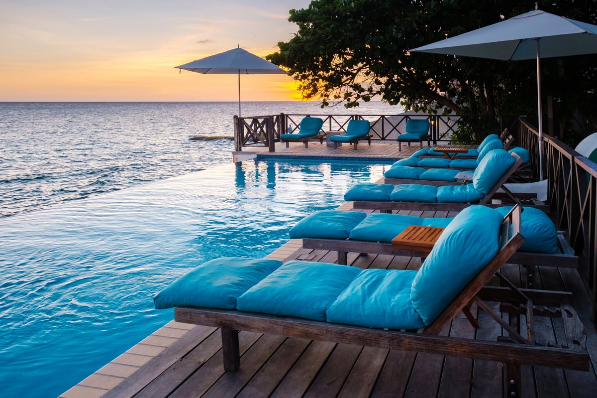 Experience tranquility as you lounge by the infinity pool at sunset in Pietermaai, Curacao